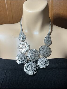 Cascading boho Silver Filigree disc with crystals and braided fabric chain.